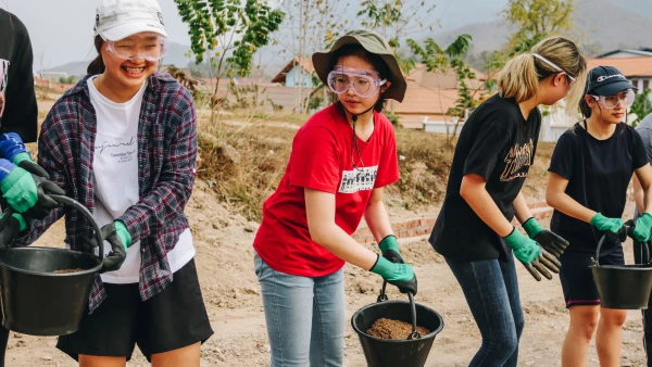 students serving the community by planting gardens near international school of qingdao high school learning service and leadership