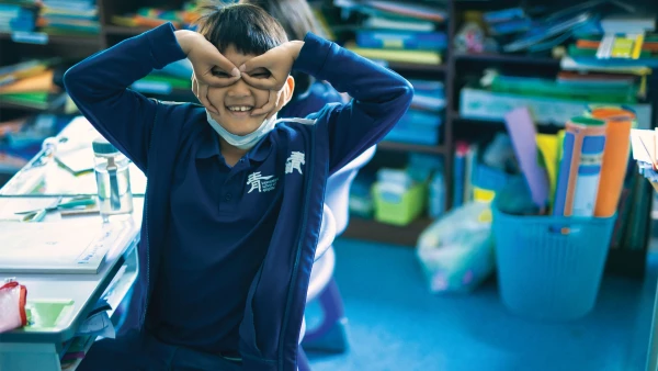 male student at international school of qingdao having fun during class