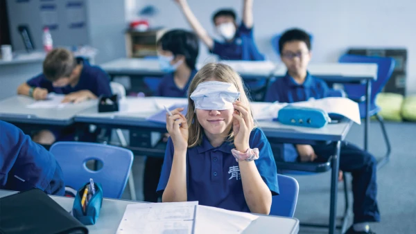 international middle school of qingdao male and female students having fun with masks