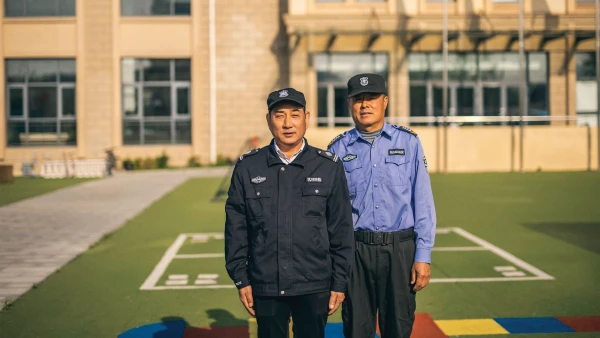 two male security guards standing outside at international school of qingdao