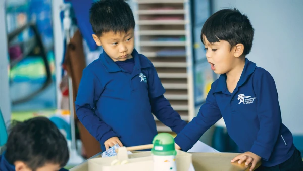 three young male students whose parents are considering the international school of qingdao cost