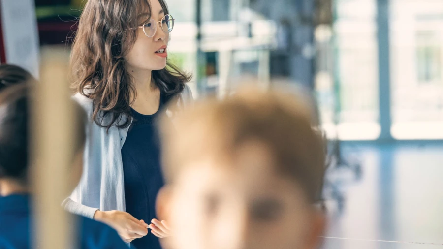 teacher in the hallway of international school of qingdao address