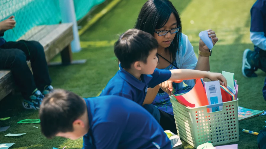 students and teacher at international school of qingdao address playing outside