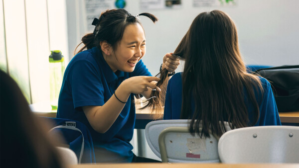 two female students enjoying time in their classroom at international school of qingdao