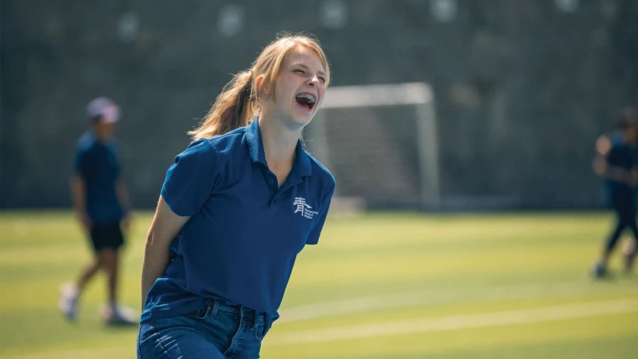 female student enjoying the soccer field at international schools in qingdao